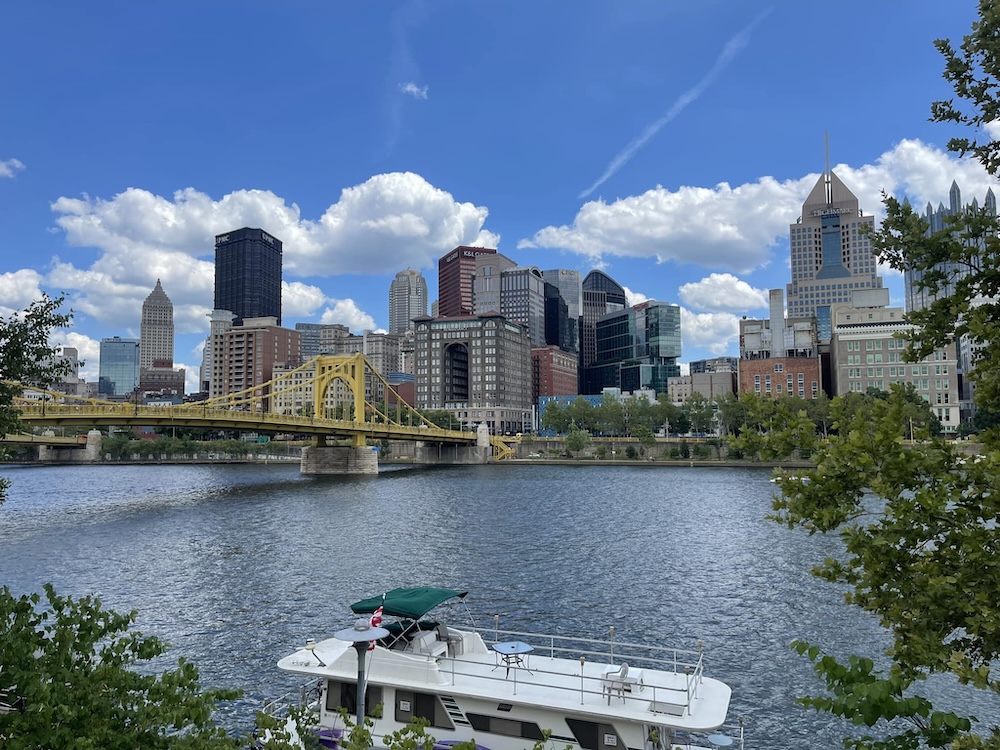 Pittsburgh city skyline with a bridge and a boat